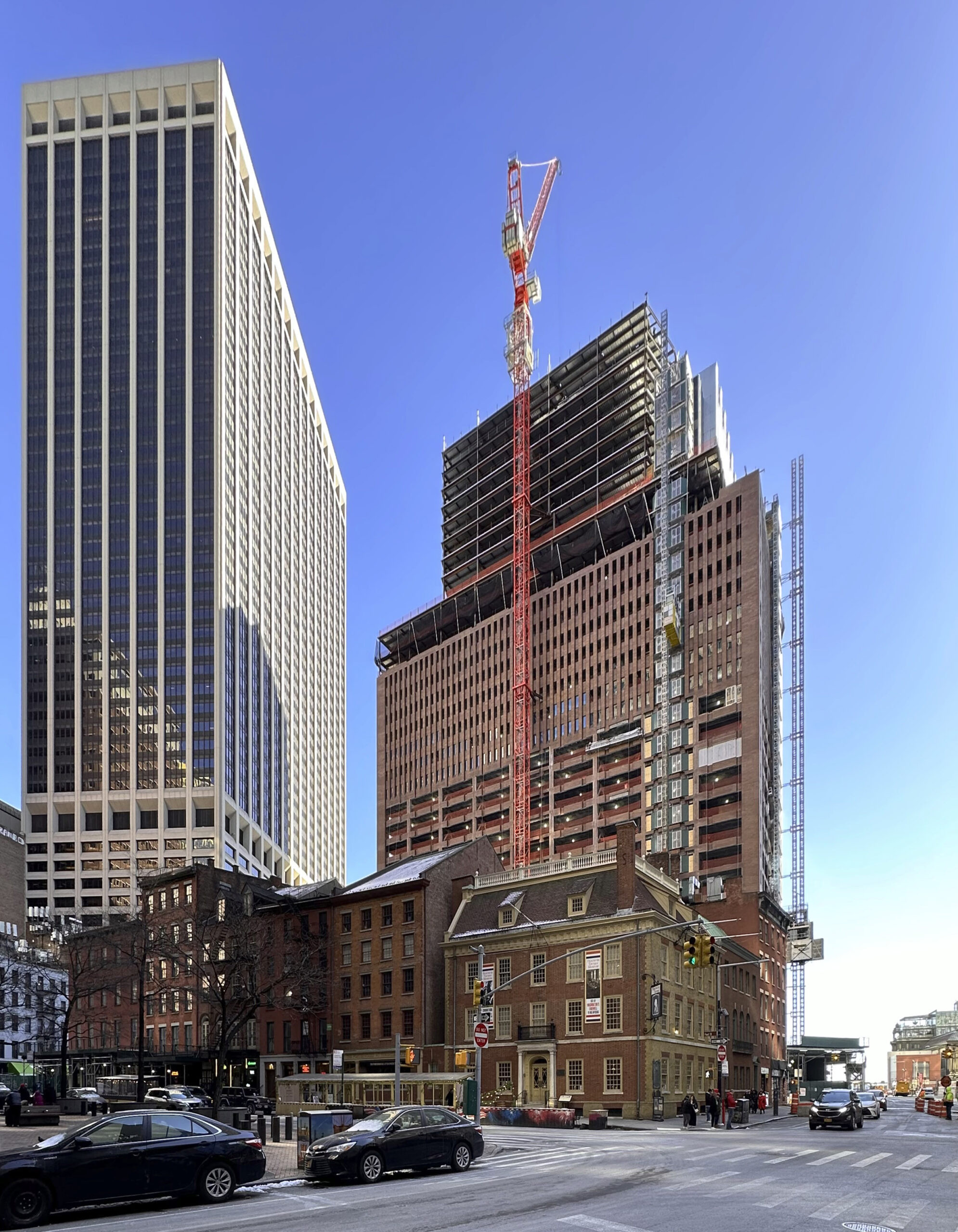 Construction progress at 25 Water Street, showcasing the steel superstructure against the New York City skyline.