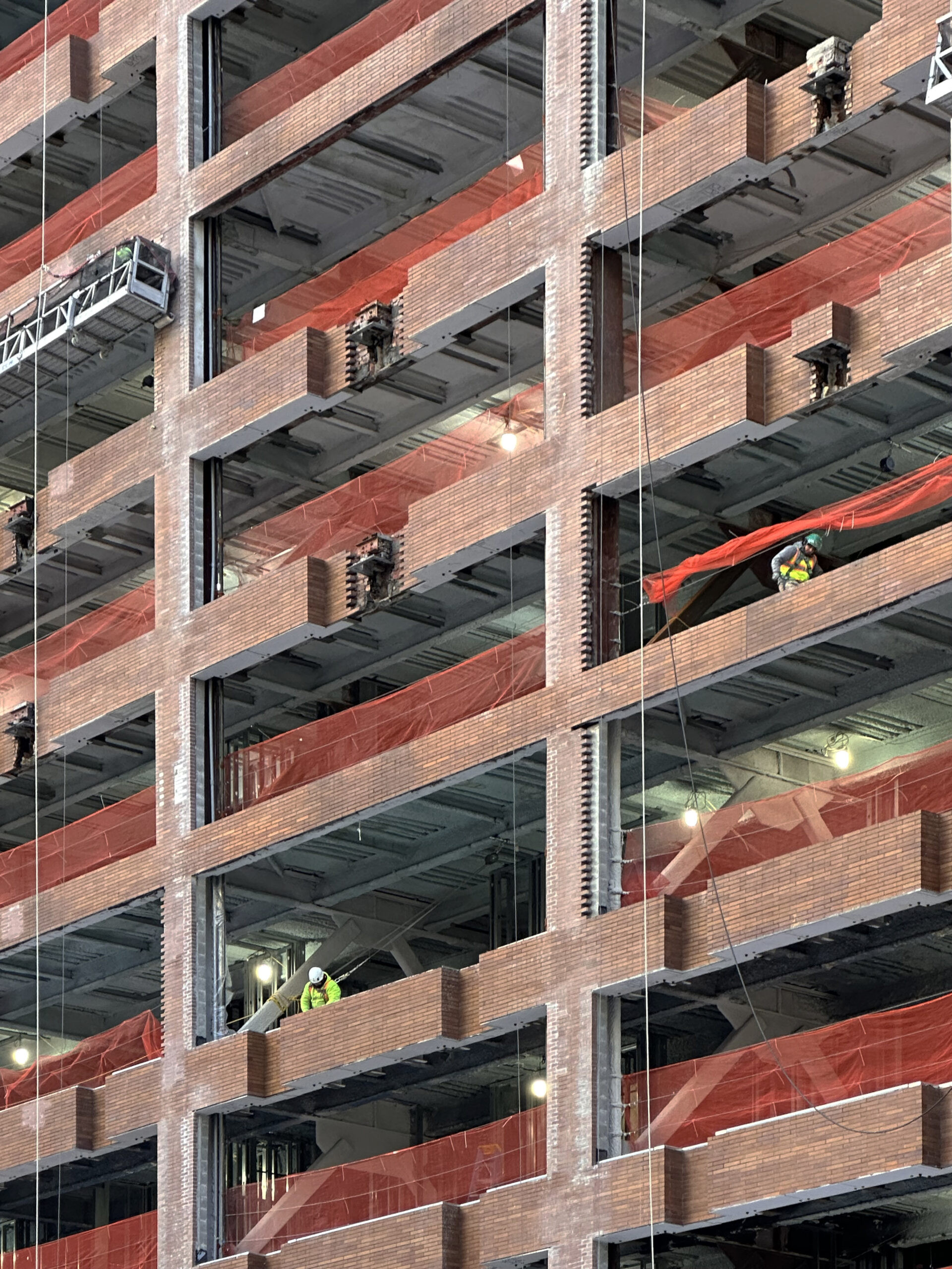 Another view of the extensive facade renovation at 25 Water Street, emphasizing the scale of the project.