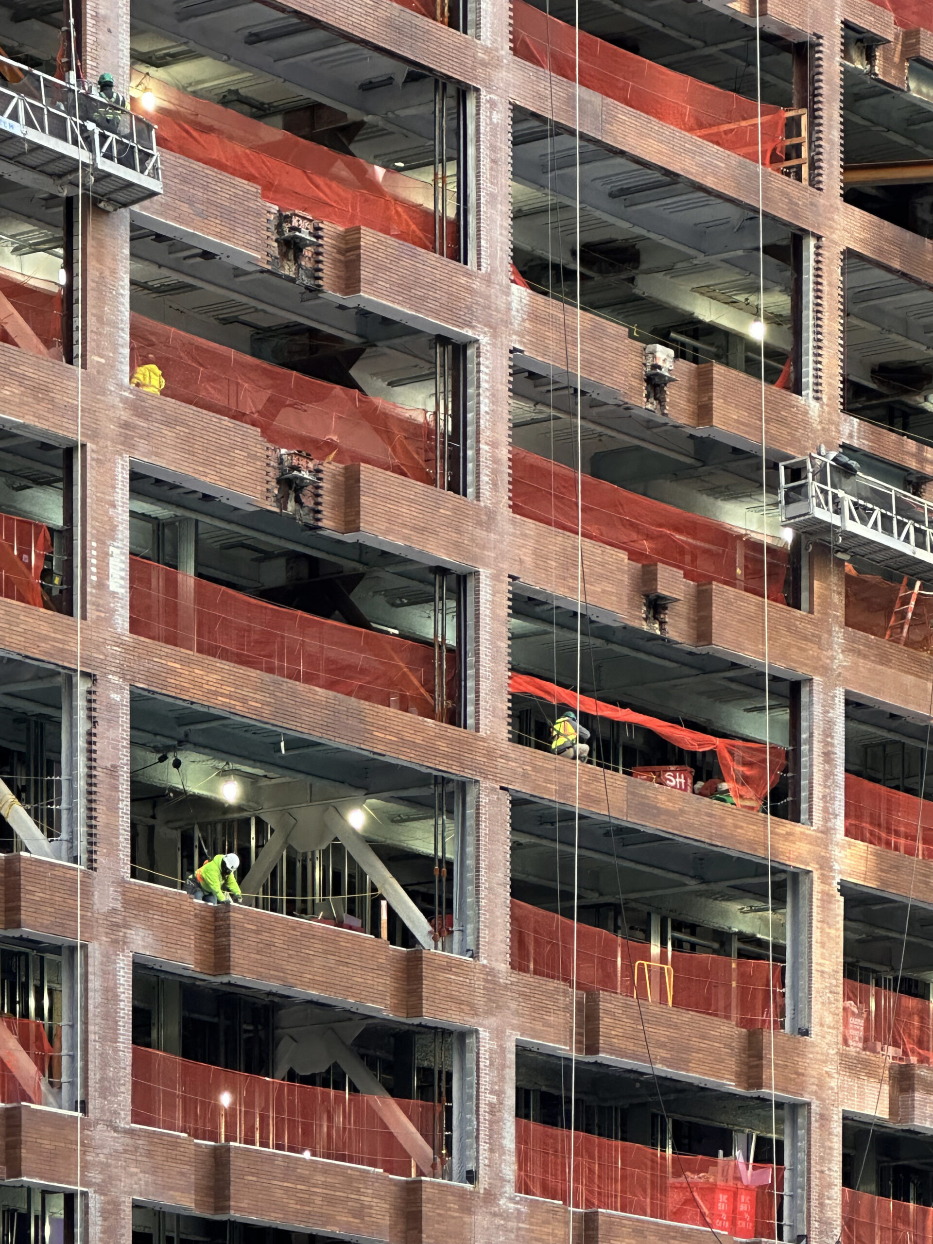 Workers on site at 25 Water Street, illustrating the human effort behind this large-scale residential conversion project.