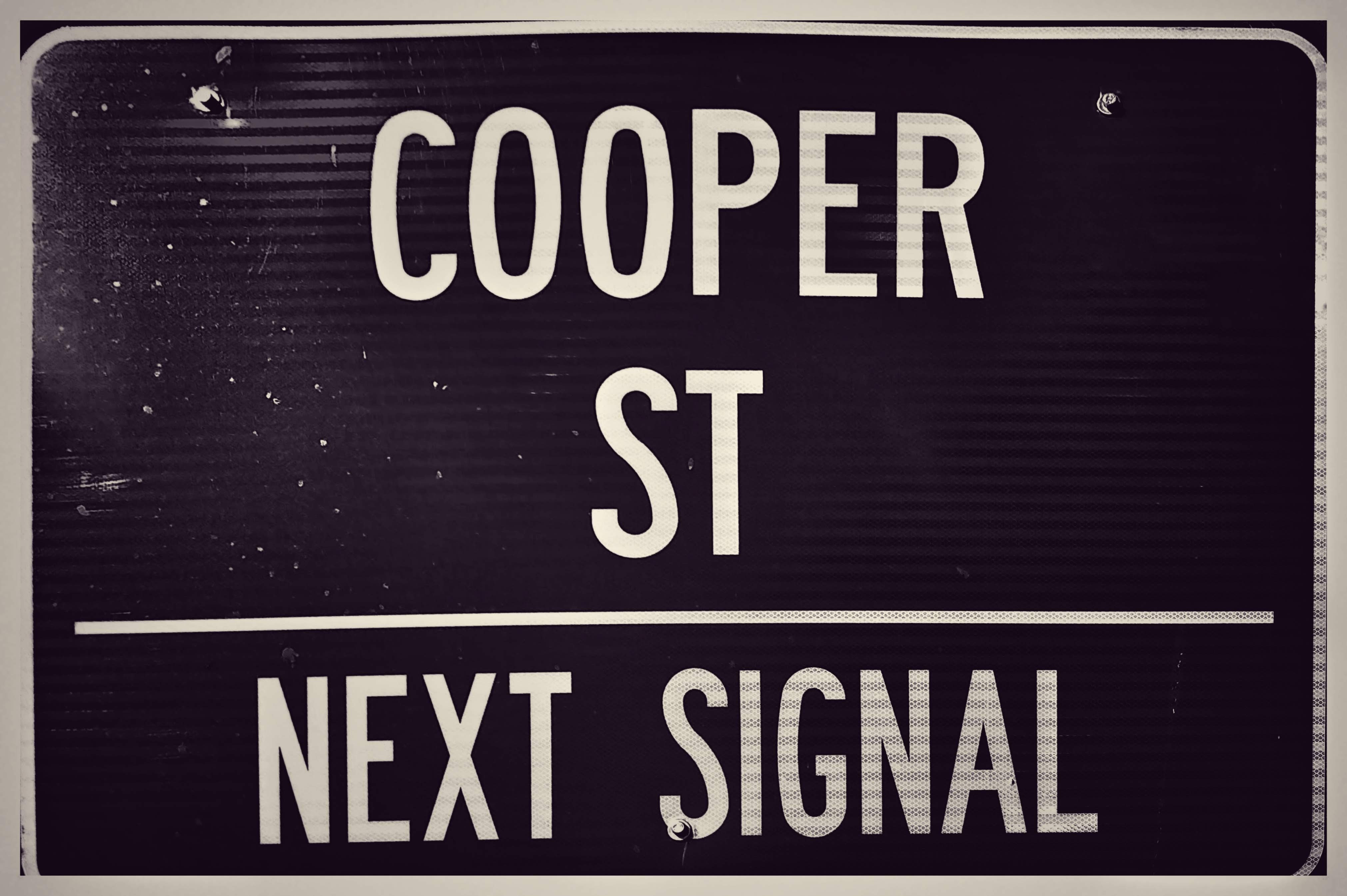 Exterior view of Cooper Street Antique Mall in Arlington, Texas, showcasing its large size and entrance.