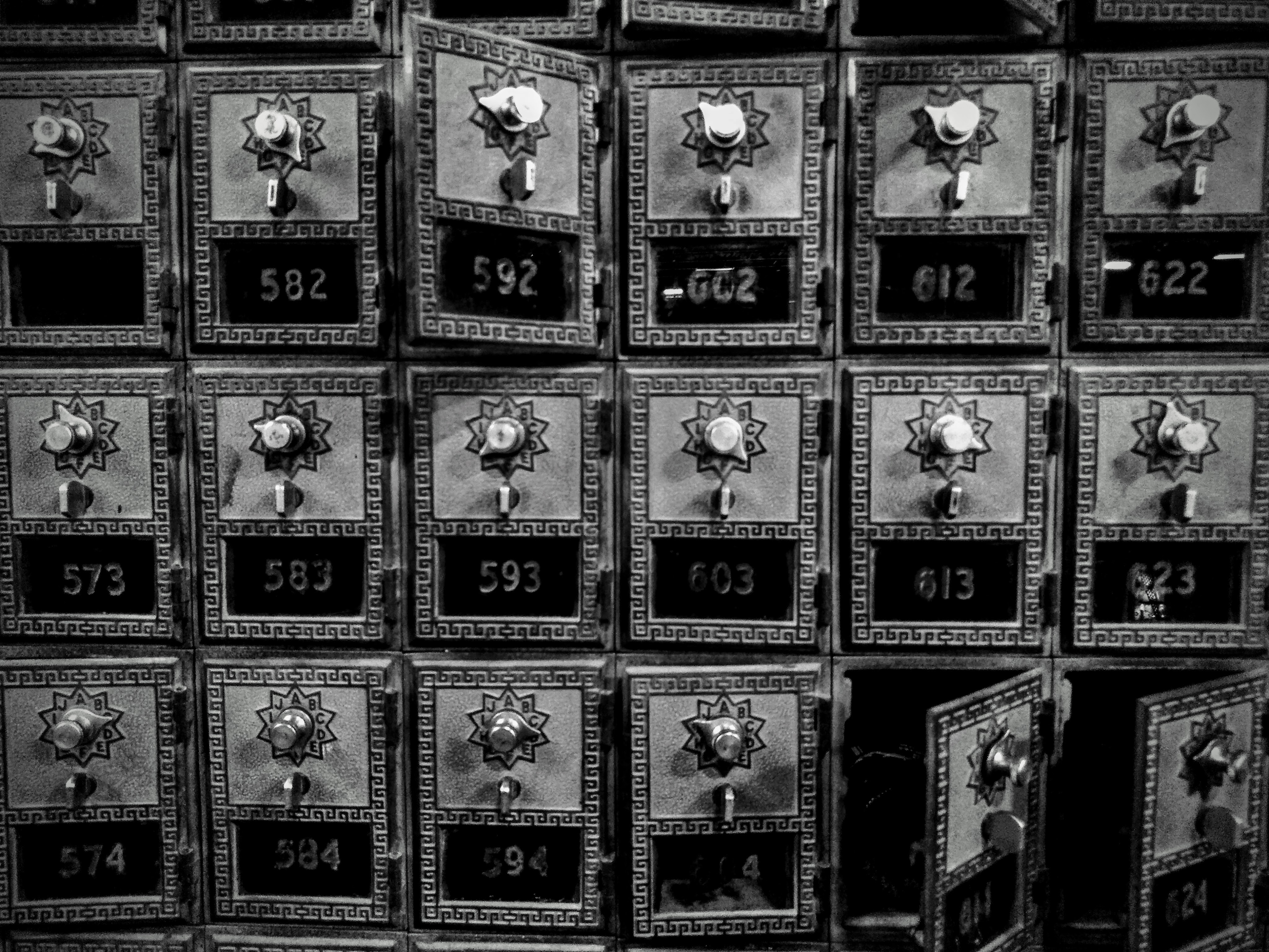Close-up of vintage post office boxes at Cooper Street Antique Mall, highlighting their aged metal and combination locks.
