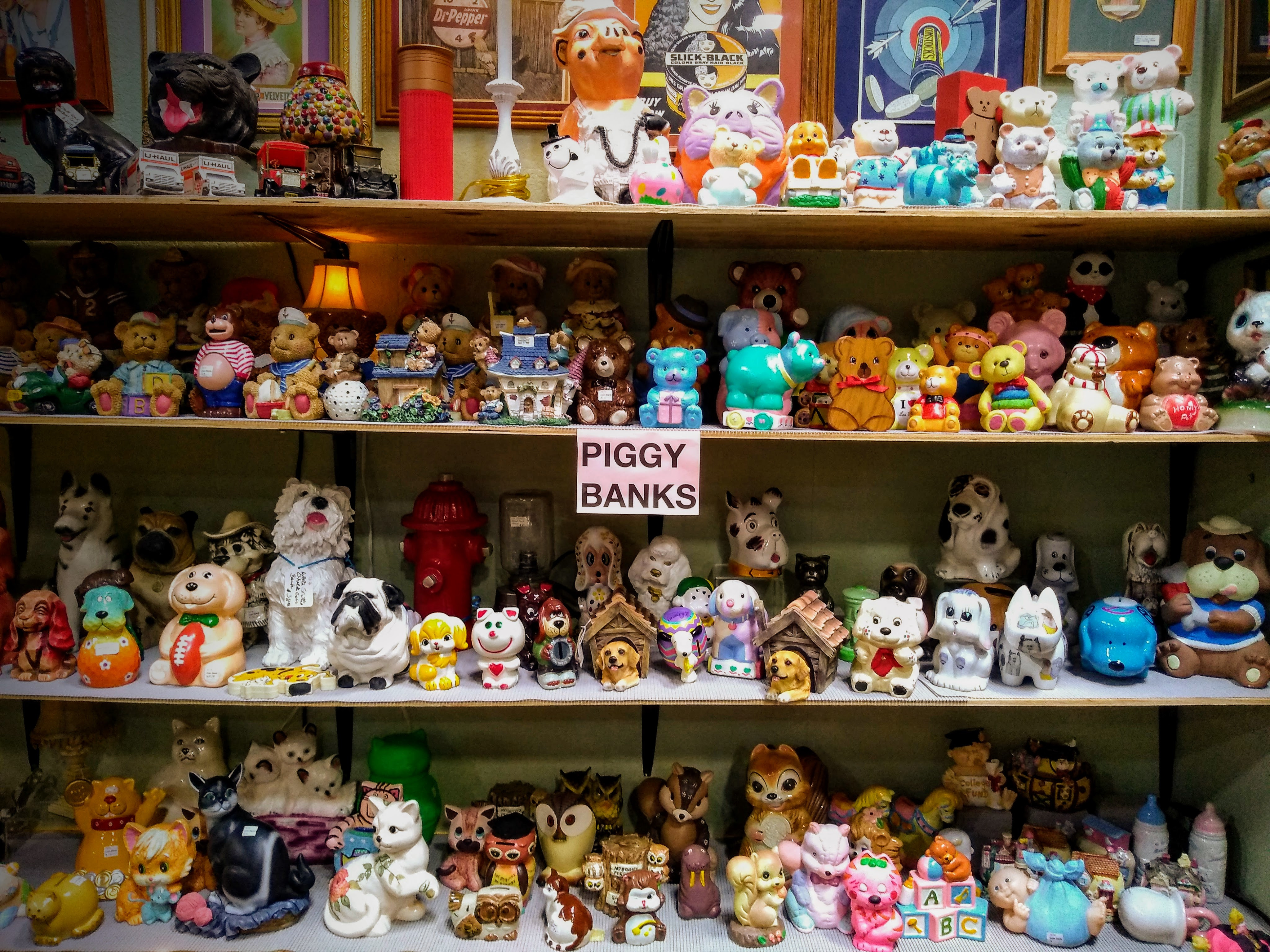 Booth filled with a vast collection of piggy banks at Cooper Street Antique Mall, showcasing the variety and quantity.