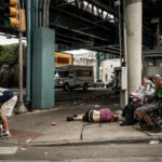 Street scene at the intersection of Kensington Avenue and Somerset Street, Philadelphia, depicting the raw reality of urban life.