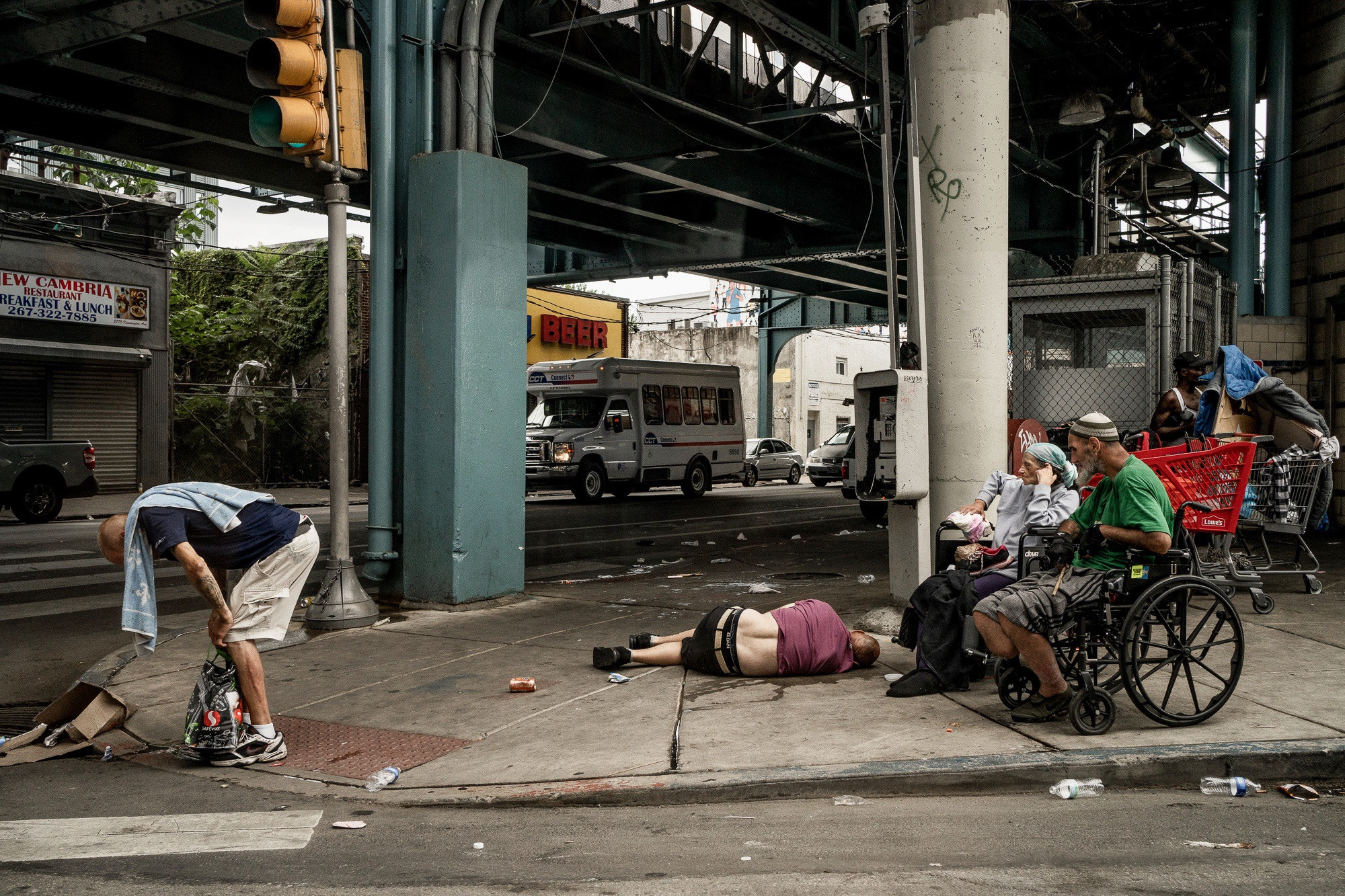 Street scene at the intersection of Kensington Avenue and Somerset Street, Philadelphia, depicting the raw reality of urban life.