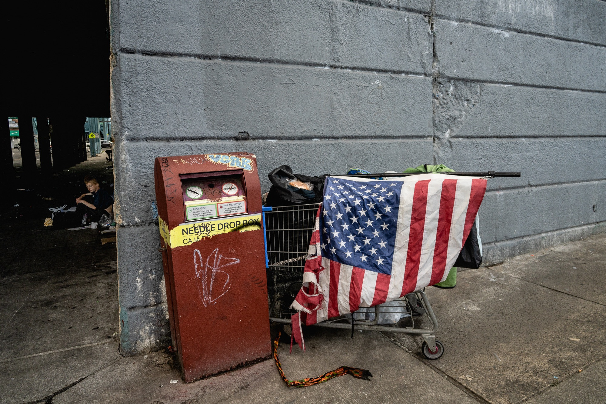 A street corner in Kensington, Philadelphia, at the junction of East Tusculum Street and Kensington Avenue, capturing the gritty atmosphere of the neighborhood.