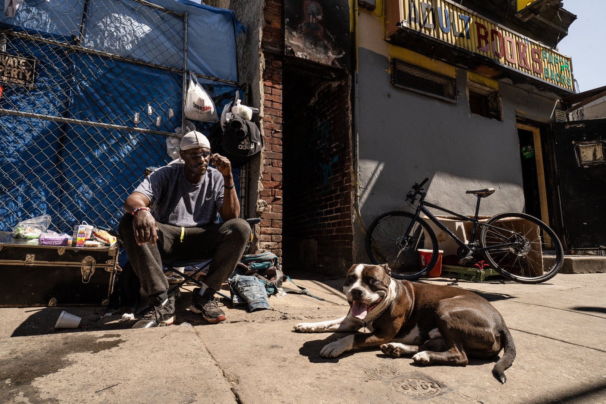 A closer view of individuals, Manny and Money, in front of the now-razed Adult Books building in Kensington, Philadelphia, capturing faces within the neighborhood's narrative.