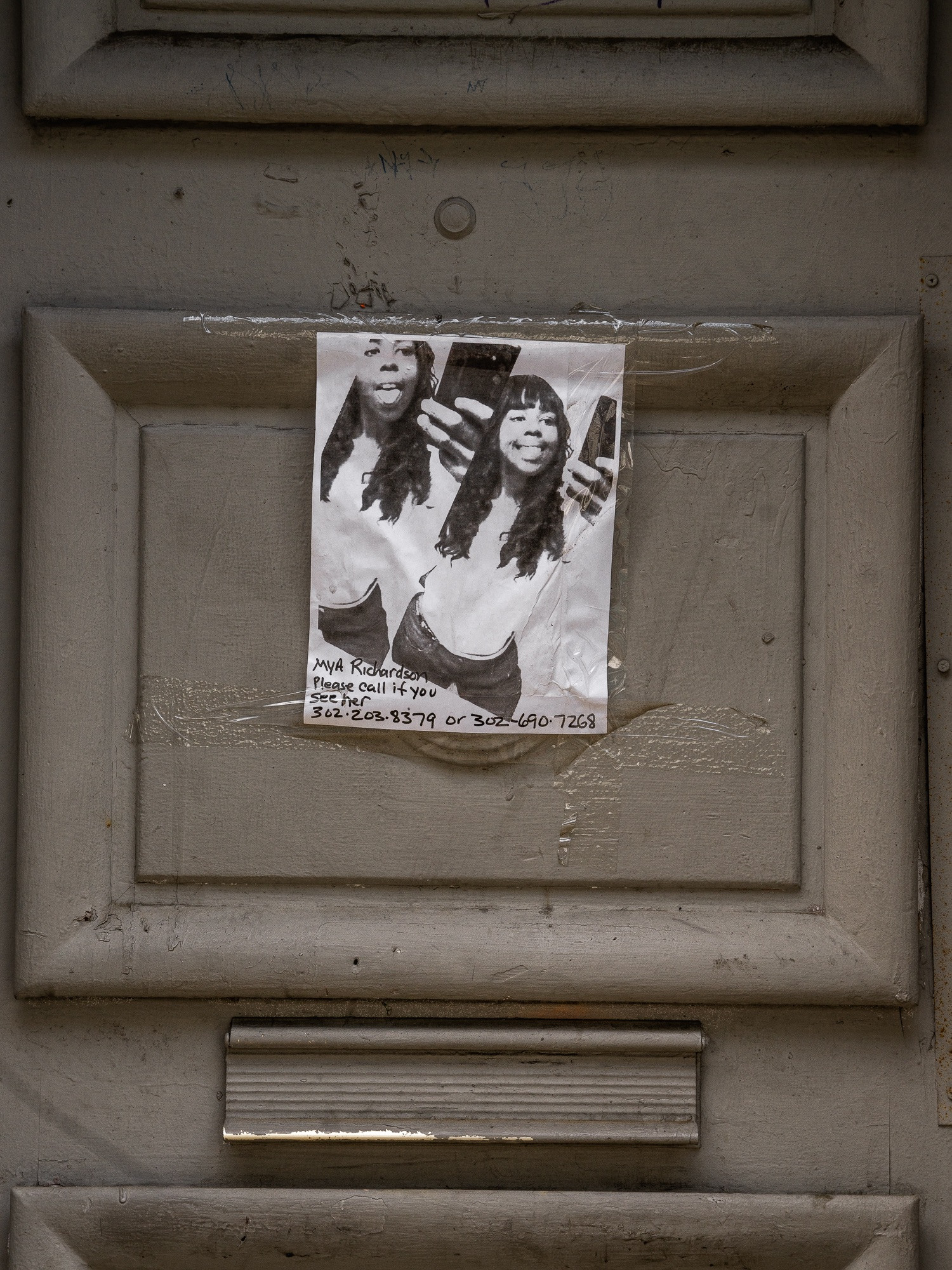A missing person flyer posted on Kensington Avenue, Philadelphia, highlighting the issue of disappearances within the neighborhood.
