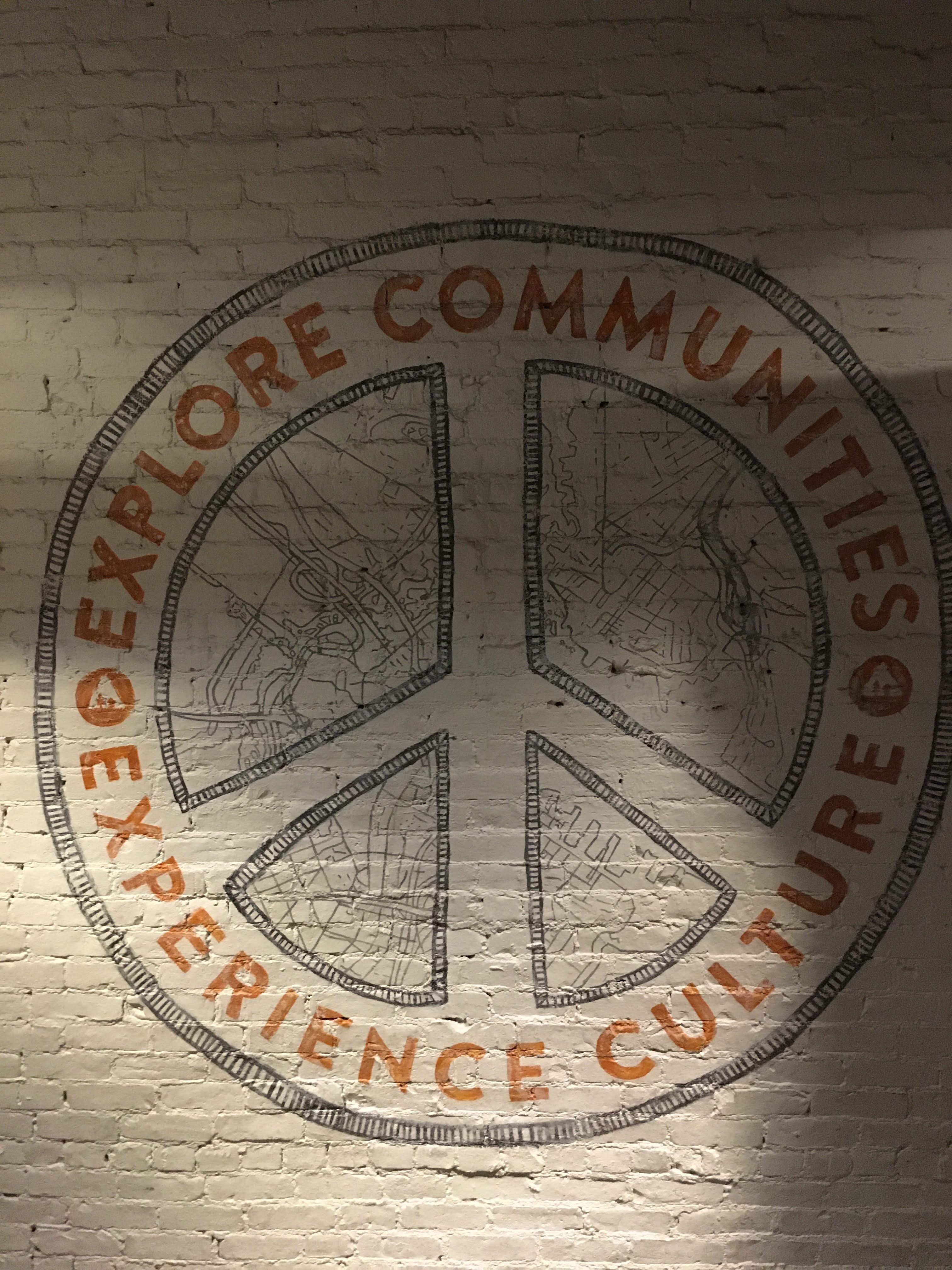 “Explore Communities, Experience Culture” on a peace sign – HI Boston (2023)