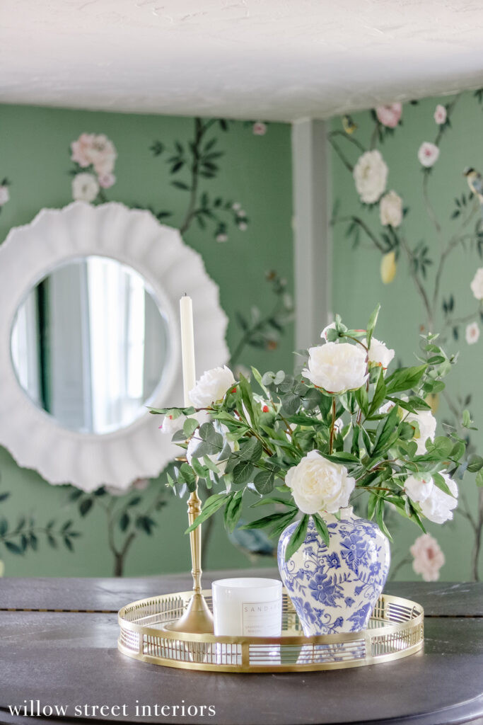 A dining room area with a stylish chandelier and dining chairs, showcasing Willow Street Interiors' design for elegant dining spaces, combining lighting and furniture for a sophisticated ambiance.