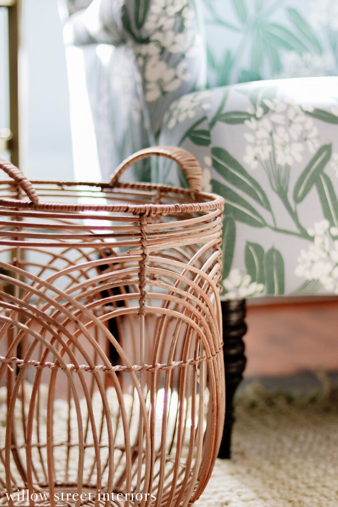A bedroom detail with a patterned headboard and nightstand, showcasing the continuation of the eclectic style into the private spaces of the Norfolk home designed by Willow Street Interiors.