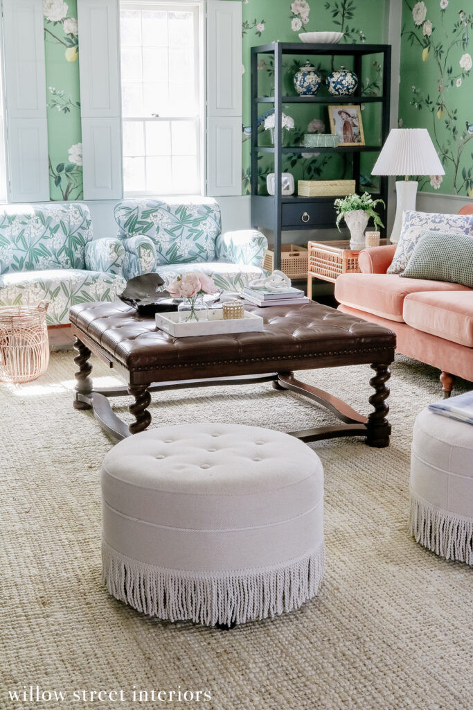 A side table with decorative books and a lamp in a Willow Street Interiors designed room, highlighting the use of lighting and accessories to enhance the ambiance and style.