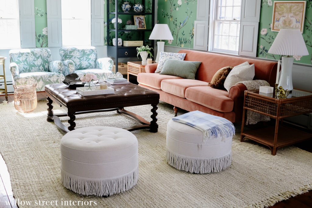 Another angle of the living room highlighting the eclectic mix of furniture styles and the use of area rugs to define different zones within the open space, as designed by Willow Street Interiors.