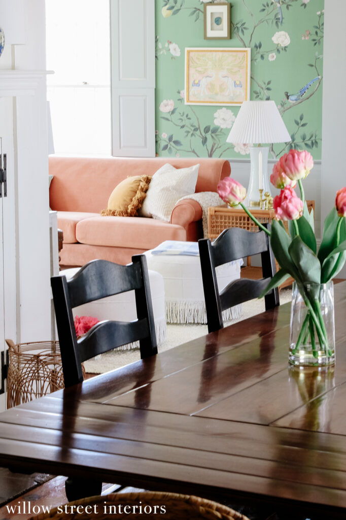 A stylish vignette featuring a vintage side table, lamp, and decorative accessories in a Norfolk home designed by Willow Street Interiors, highlighting the blend of vintage and modern elements.