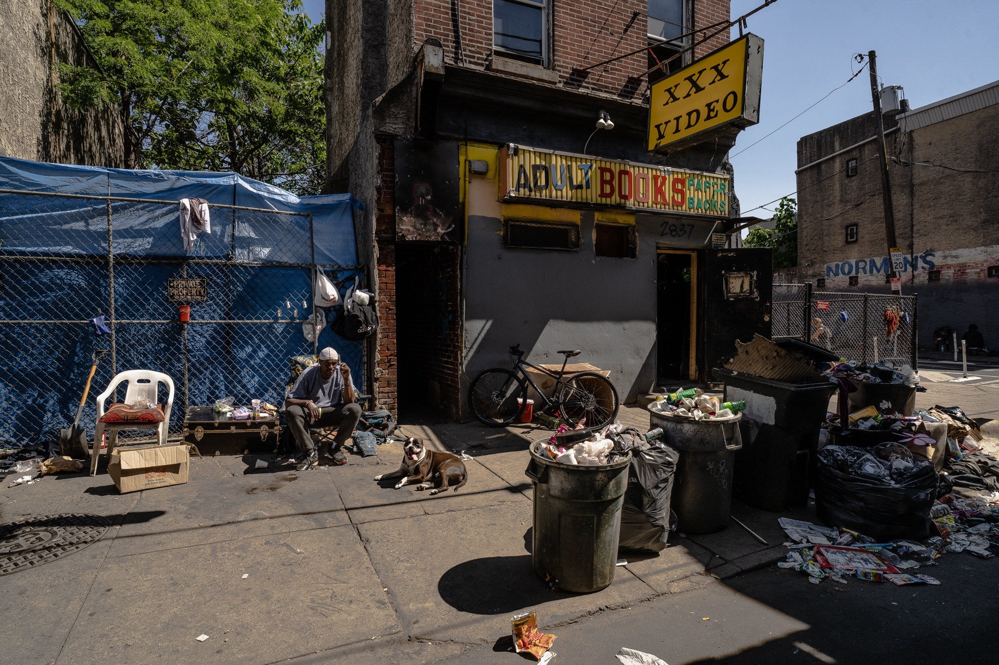 The remnants of the Adult Books storefront on Kensington Avenue, Philadelphia, formerly a hub for drug activity and exploitation, now demolished, symbolizing a complex history.