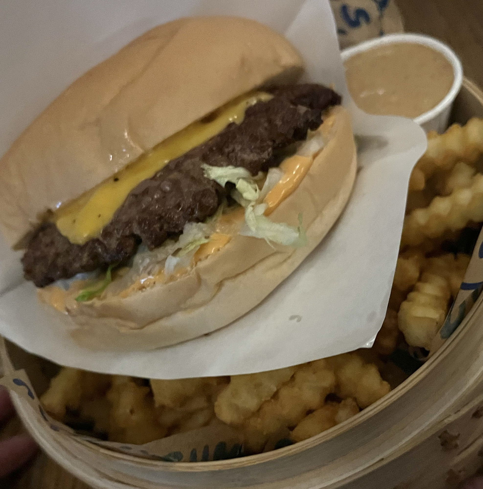 A juicy hamburger with golden fries, a popular choice at Posthus Matholl Food Hall in Reykjavik.
