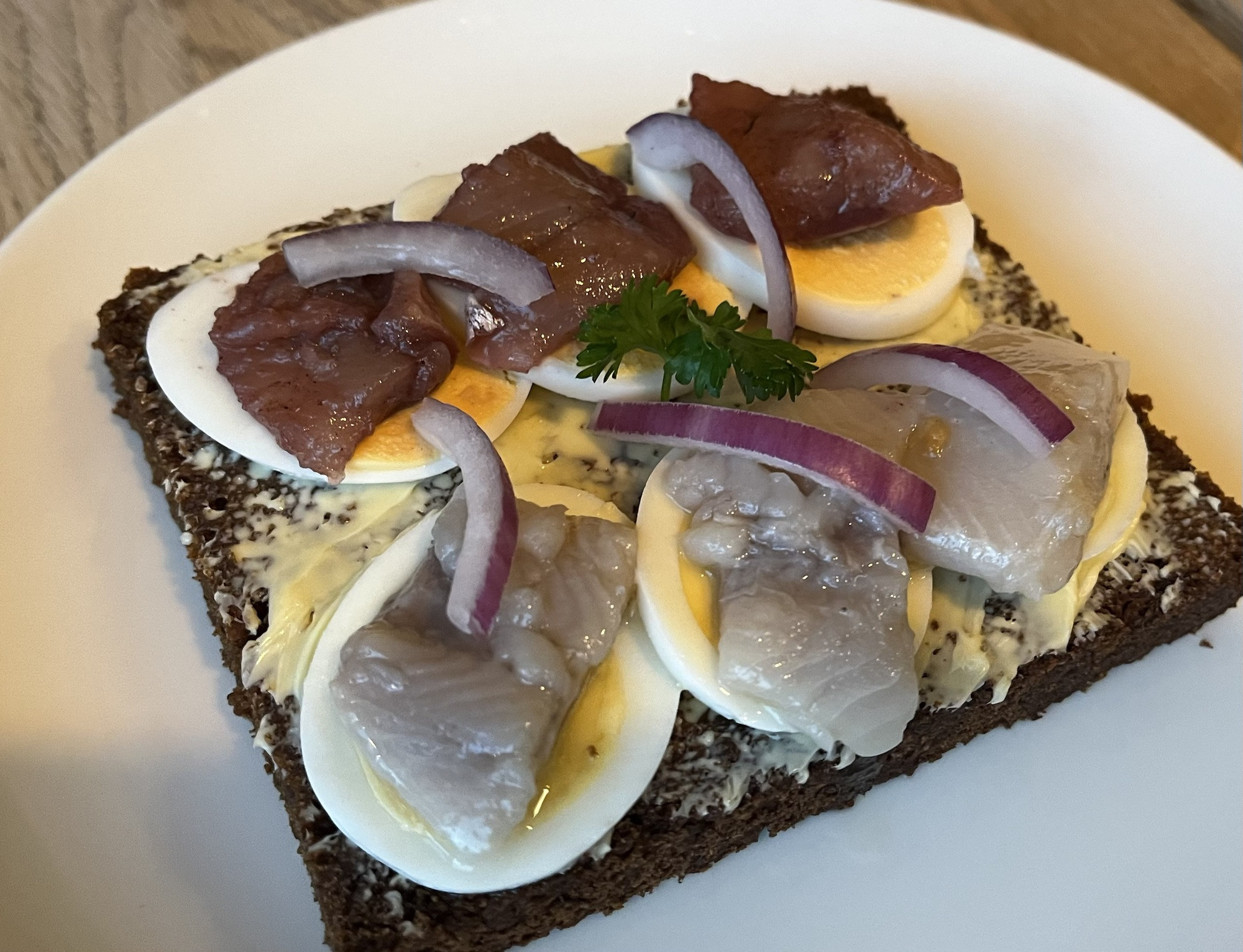 Homemade rye bread topped with egg and herring or smoked fish, a traditional Icelandic breakfast at Cafe Loki, Reykjavik.