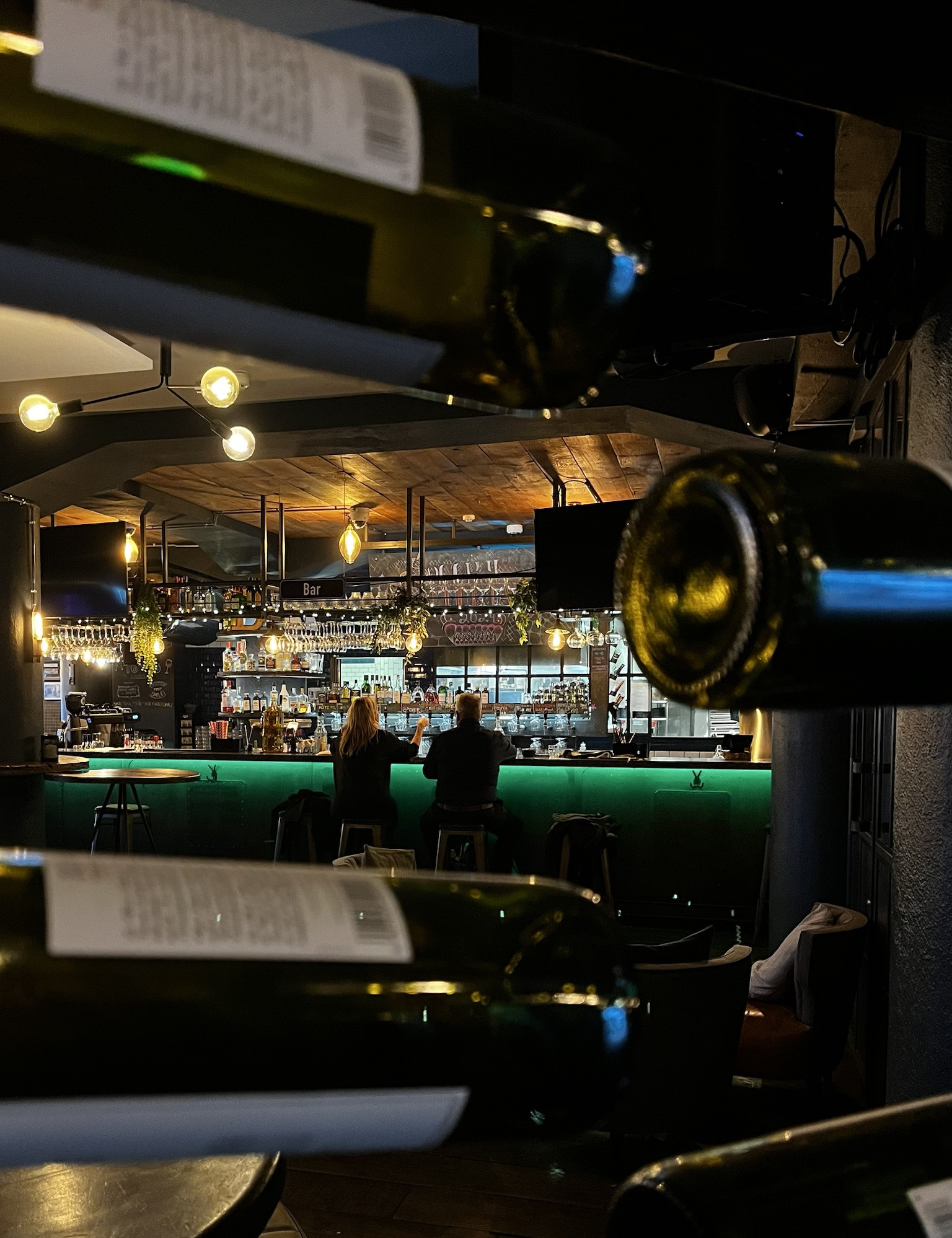 People enjoying drinks and conversation at a Reykjavik brewery, creating a relaxed and social atmosphere.