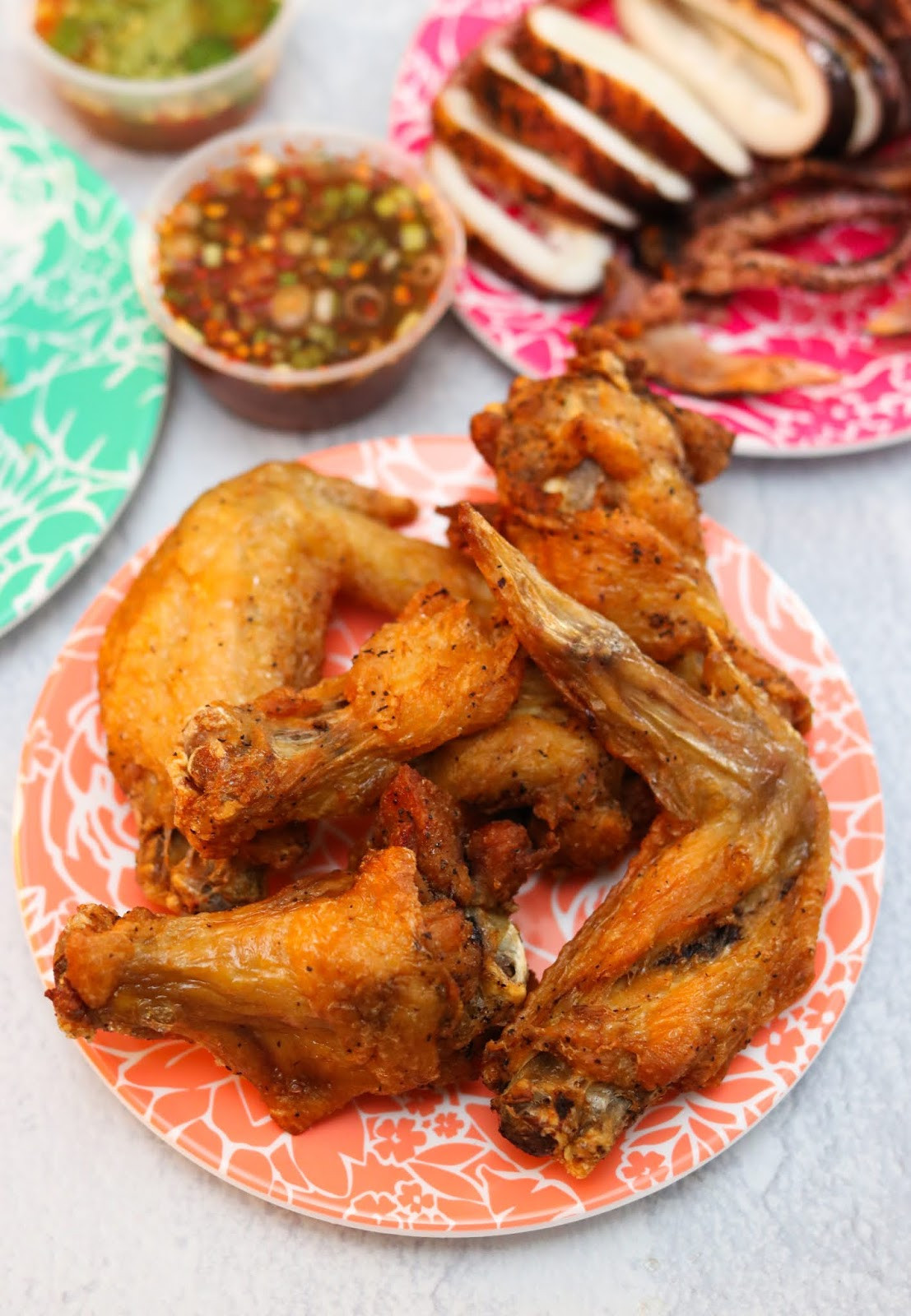 A vibrant and flavorful plate of Peek Gai Tod, crispy Thai chicken wings, served at JJ Thai Street Food in Chicago.