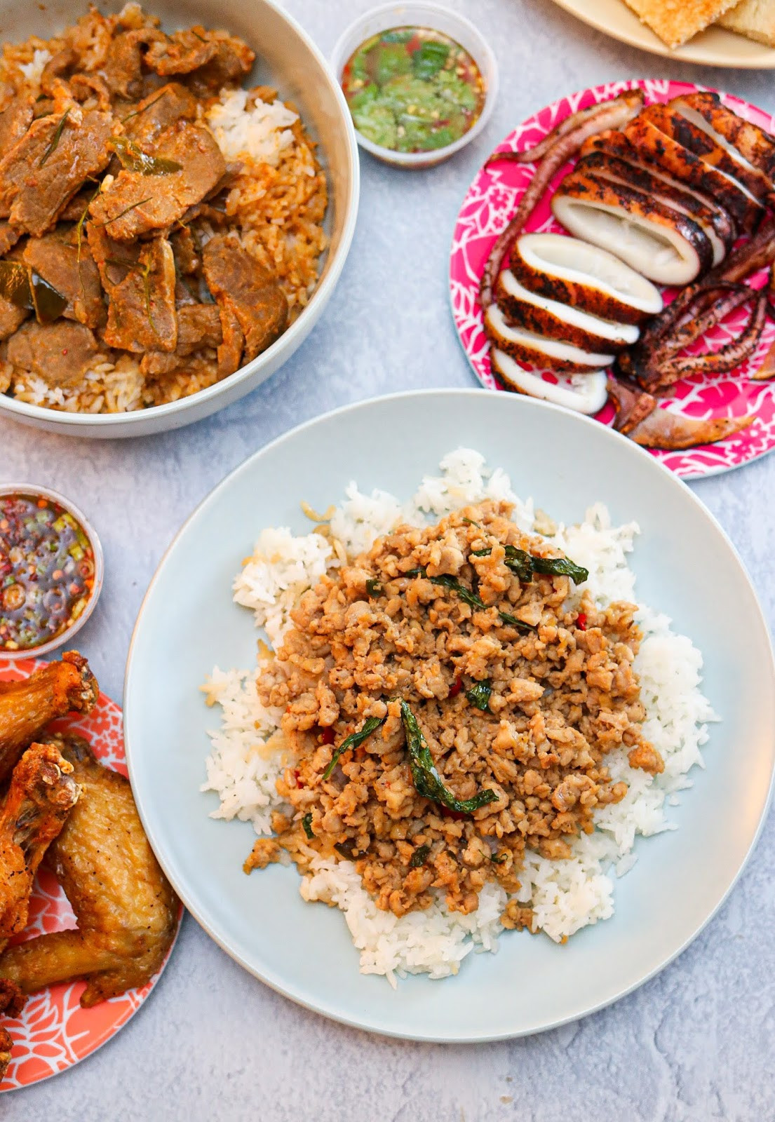 A plate of Khao Lard Ka Praw Gai, flavorful Thai stir-fried ground chicken with basil and chili peppers, served with jasmine rice at JJ Thai Street Food.