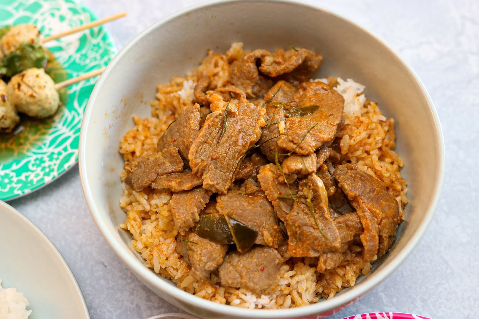 A comforting bowl of Khao Panaeng Neua, traditional Thai Panang beef curry, served over fragrant jasmine rice at JJ Thai Street Food.