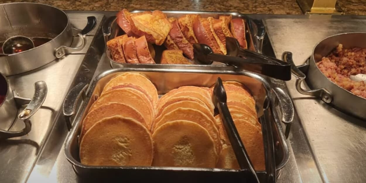 Assortment of breakfast foods including eggs, bacon, and pastries at Main Street Station Buffet
