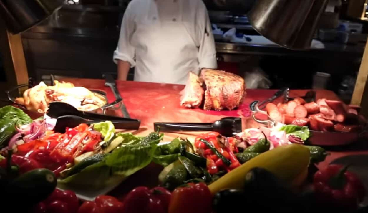 A chef carving prime rib at the carving station of Main Street Station Buffet