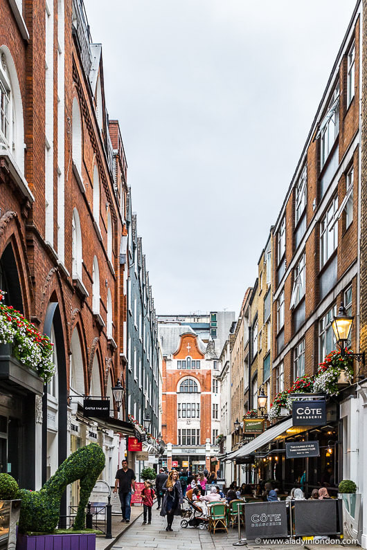 Shoppers strolling along St Christopher's Place near Marylebone High Street, enjoying the pedestrianized shopping area.