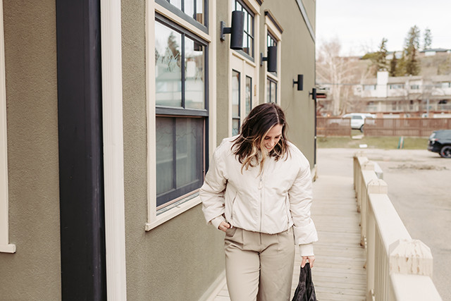 Full body shot of a person wearing a monochromatic taupe outfit in a street style setting