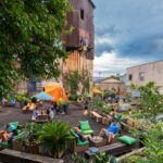 Visitors relaxing in the lush outdoor setting of the PHS Pop Up Garden in Philadelphia.