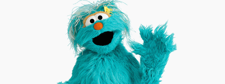 Rosita Sesame Street blue monster character playing guitar and smiling