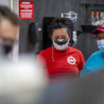Miriam Espaillat, co-founder of Sabor Latin Street Grill, stands proudly in her restaurant, showcasing her commitment to community and authentic Latin cuisine.