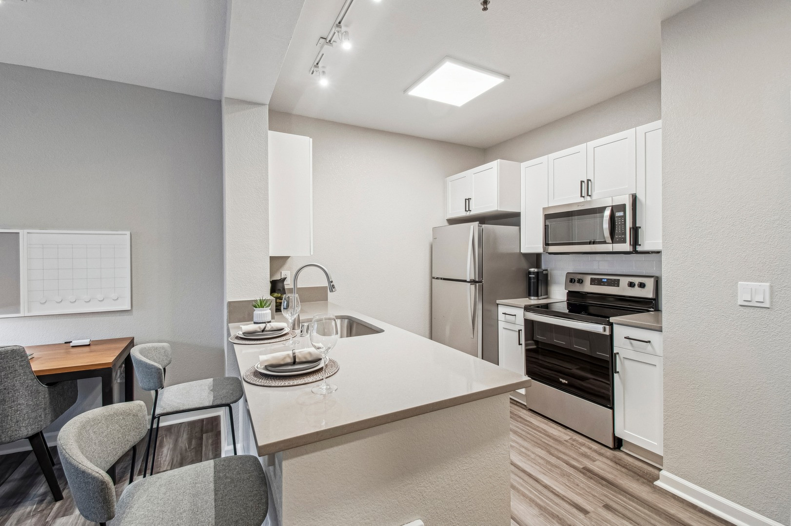 Modern apartment living room with large windows at Bay House Emeryville
