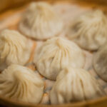Delicious soup dumplings, a culinary highlight of Chinatown in Manhattan, New York, representing the authentic Chinese food experiences available.