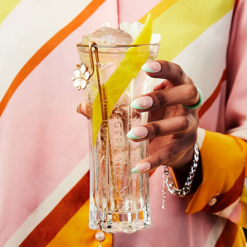 A refreshing St-Germain Spritz cocktail in a glass with ice and a lemon twist.