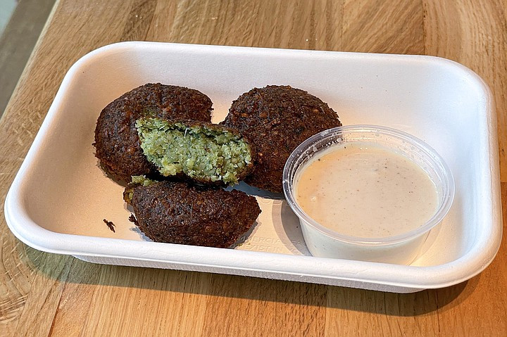 Tahini's freshly made falafel, vibrant green and herbaceous, exemplifying authentic Middle Eastern street food made with quality ingredients.