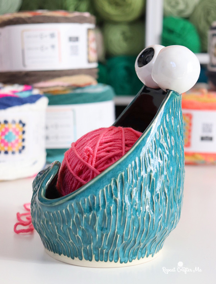 Side view of a Yip Yip Yarn Bowl highlighting its shape and opening designed to smoothly dispense yarn while crafting
