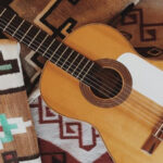 Close-up of a guitar body, showcasing the strings and soundhole
