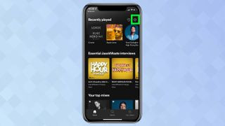 A screenshot from an iPhone showing the Spotify app with the settings cog highlighted